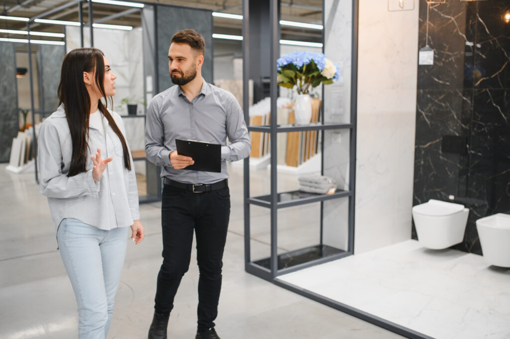 Female client talking with seller in showroom